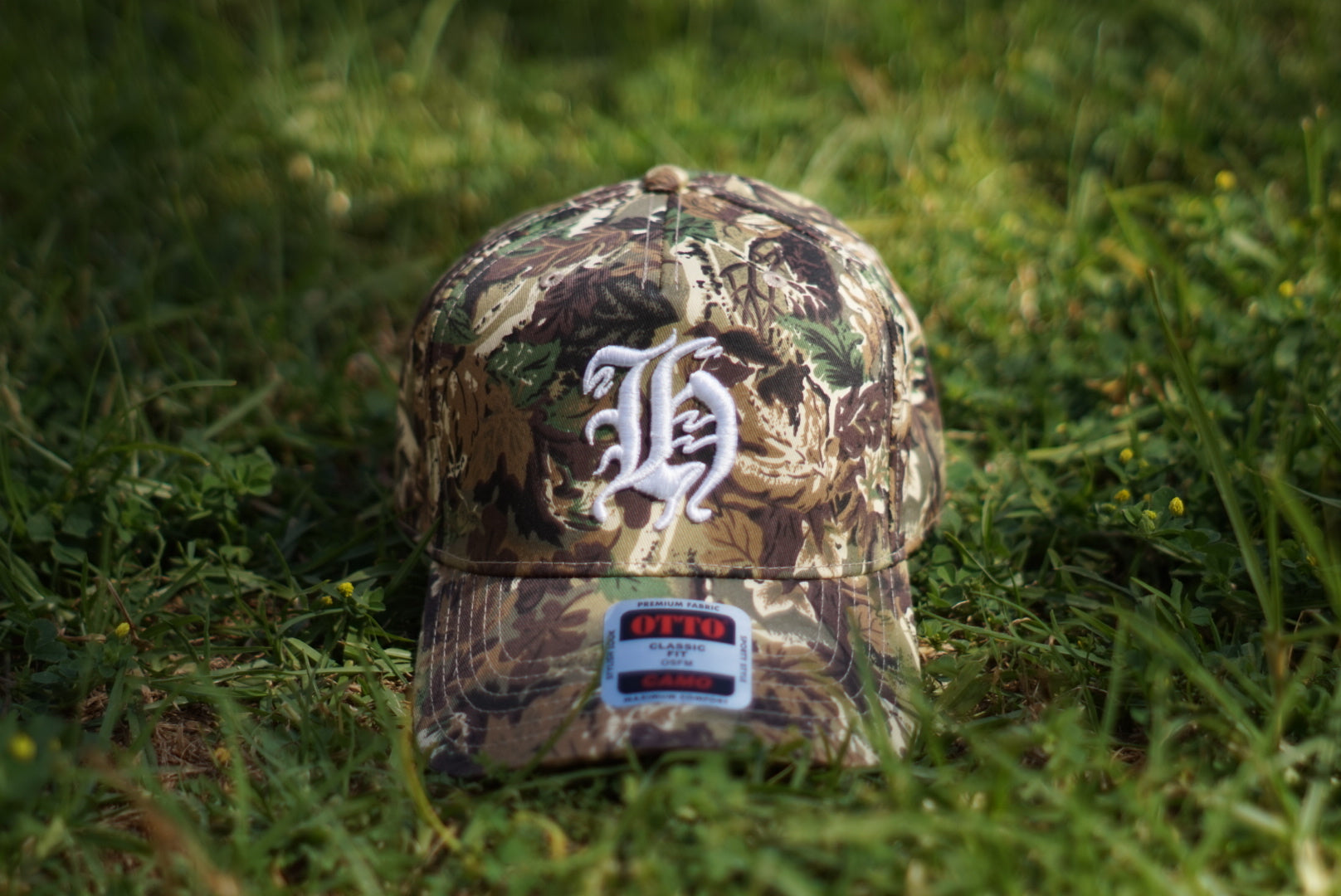 "H" LOGO CAMO TRUCKER HAT