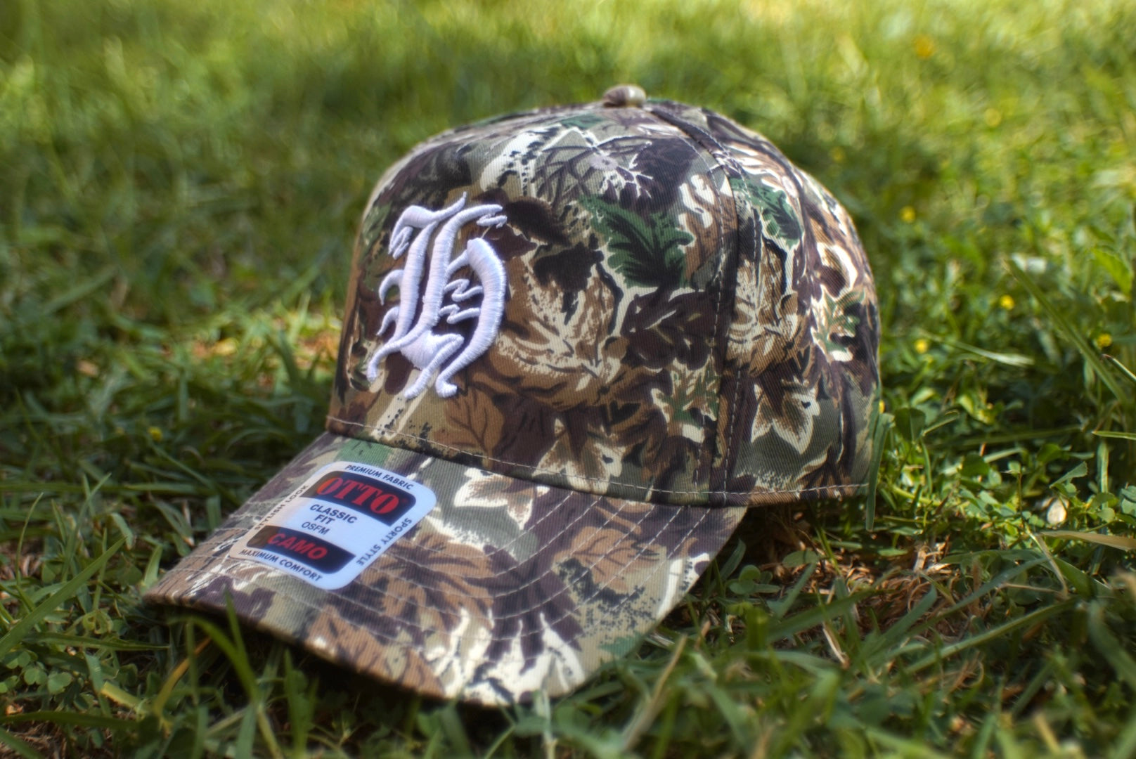 "H" LOGO CAMO TRUCKER HAT